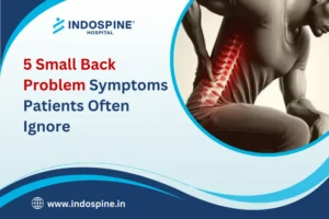 Man holding lower back in pain highlighting common Back Problem Symptoms patients often ignore.